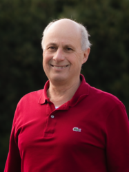 Grüner Fraktionär Rolf Becker, im Hintergrund unscharfe dunkelgrüne Vegetation