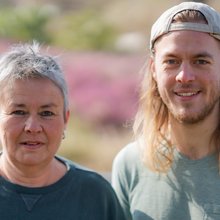 Grüne Fraktionsvorsitzende Suse Stobbe und Julian Schlumberger, vor unscharfer, rötlich-gelber Vegetation